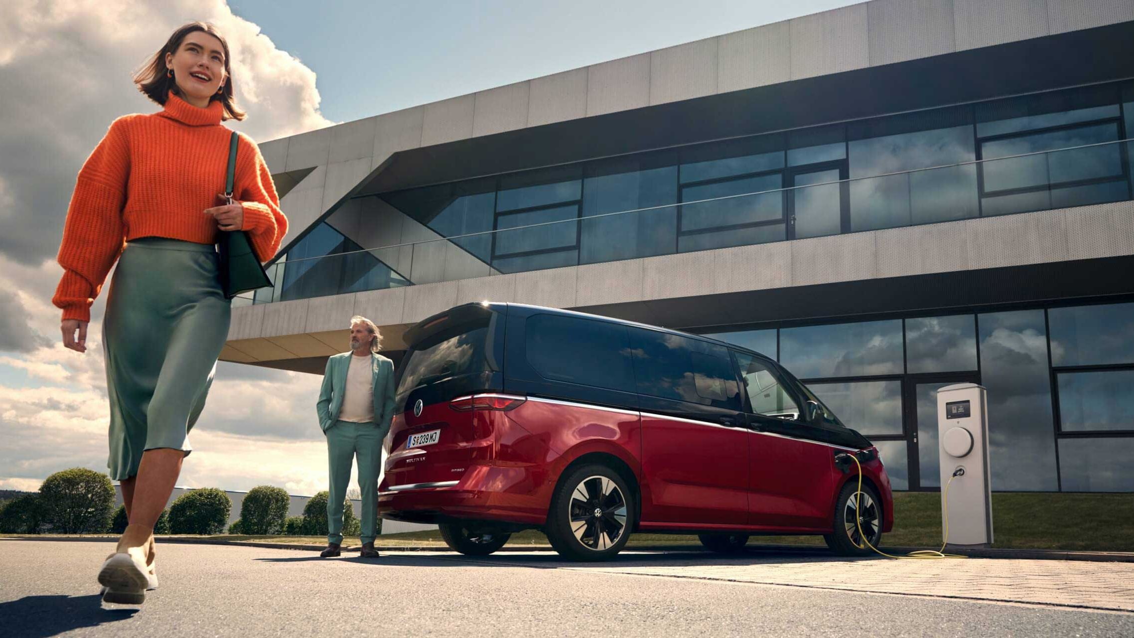 Der VW Multivan steht an einer Ladesäule.