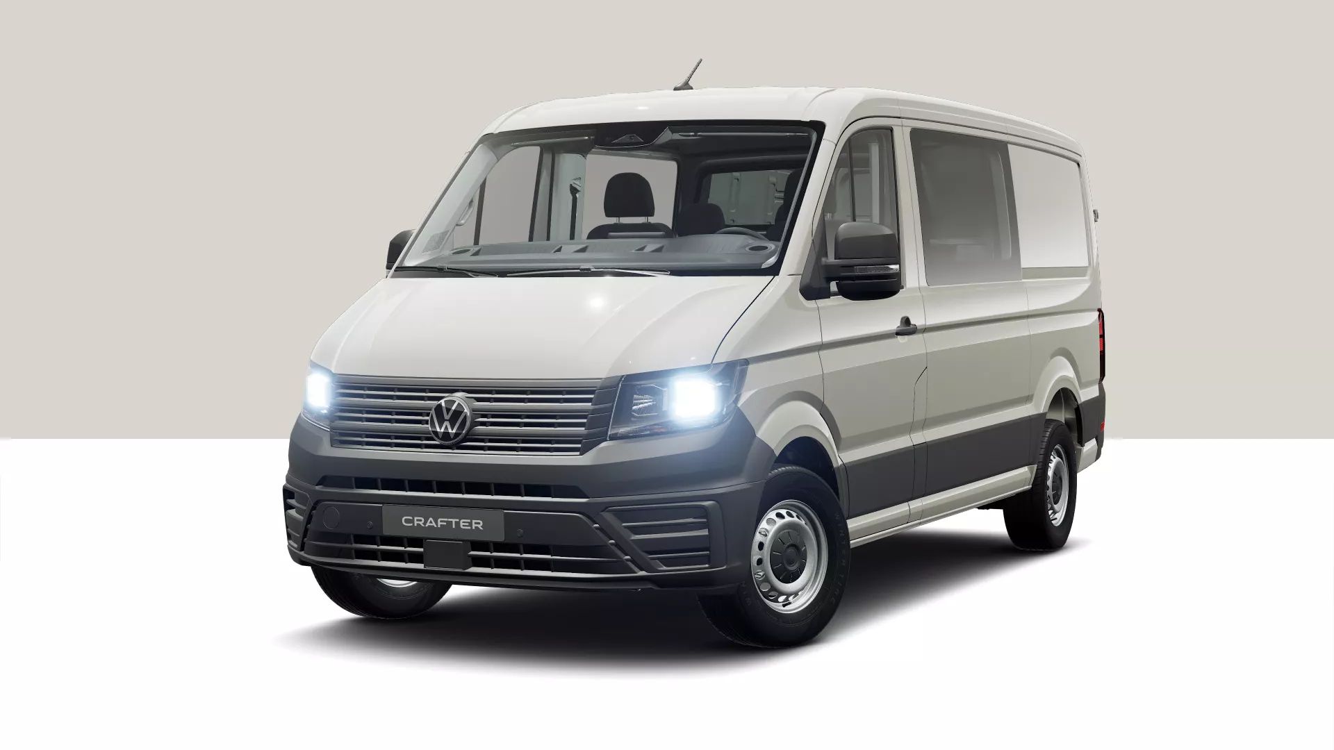 Ein weißer Volkswagen Crafter Transporter steht vor einem neutralen Hintergrund. Das Fahrzeug ist von vorne und leicht seitlich zu sehen. Die Scheinwerfer sind eingeschaltet.