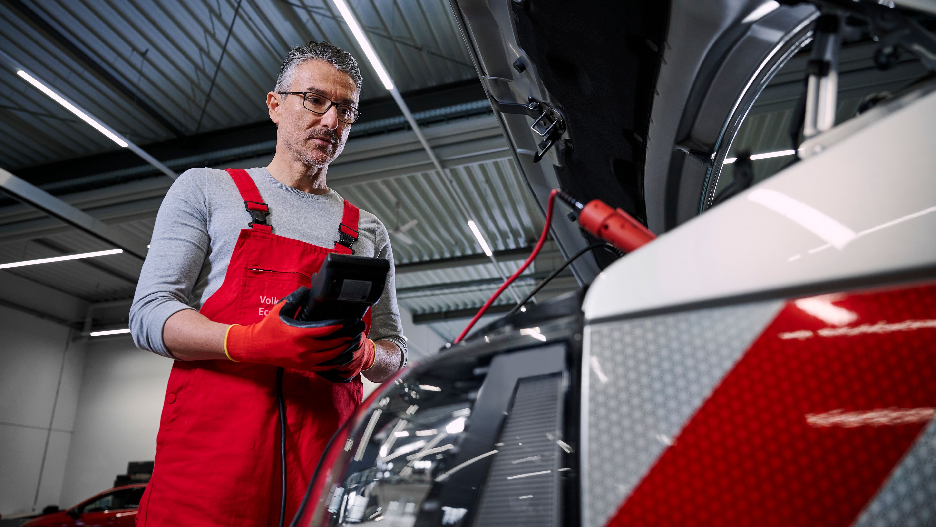 Ein Volkswagen Mechaniker überprüft die Batterien eines Volkswagen